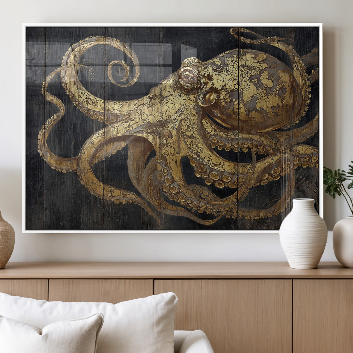 A detailed gold illustration of an octopus on black wooden planks, showing its intricate tentacles and textured skin in an artistic style.