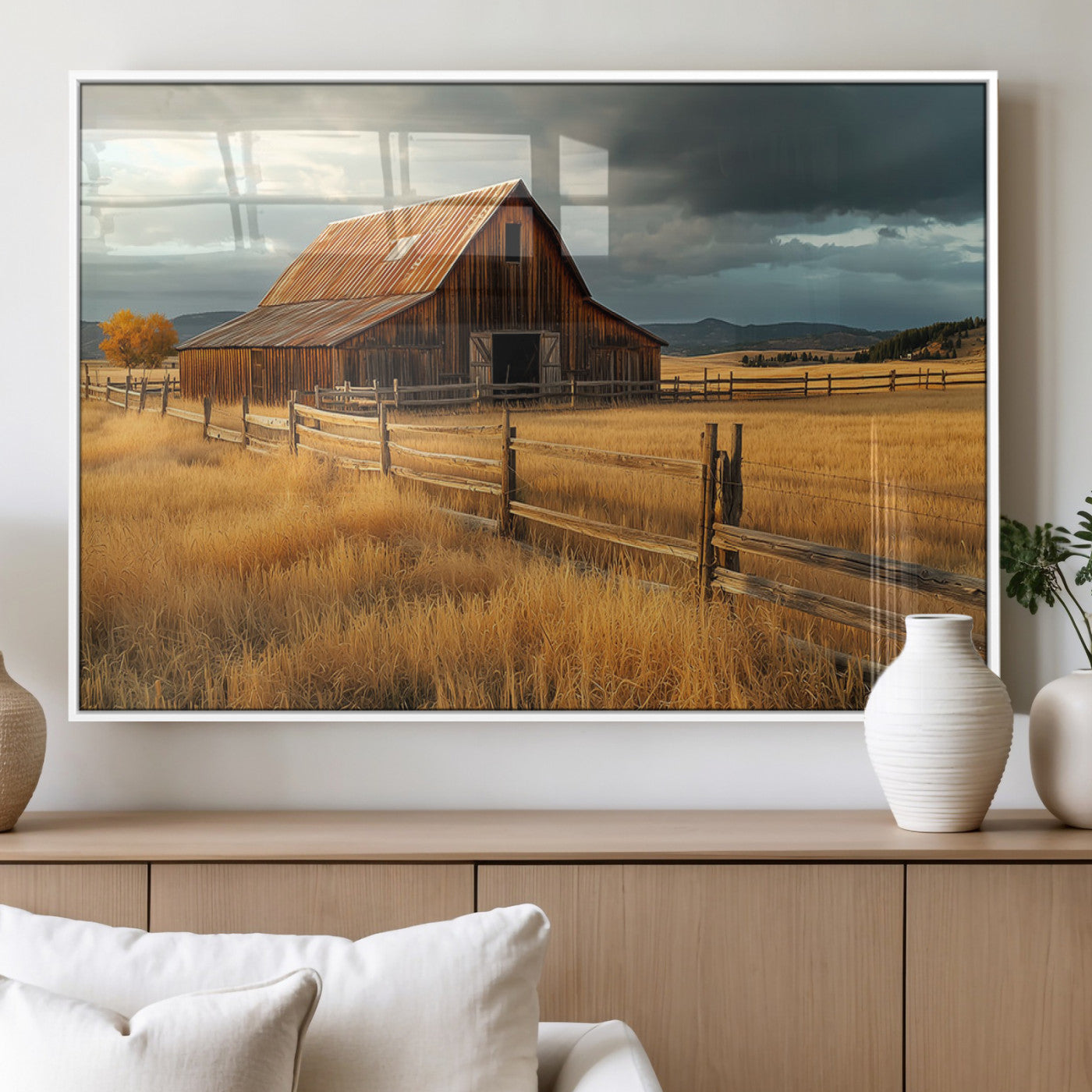"Golden fields surrounding a rustic barn with a weathered roof, a wooden fence, and dramatic skies with sunlight breaking through the clouds."