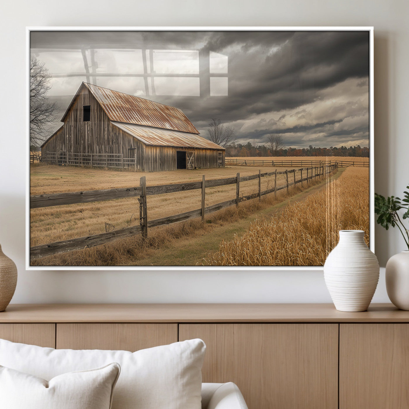 "Rustic barn with a weathered metal roof, surrounded by a wooden fence and golden fields under an overcast sky with dramatic clouds."