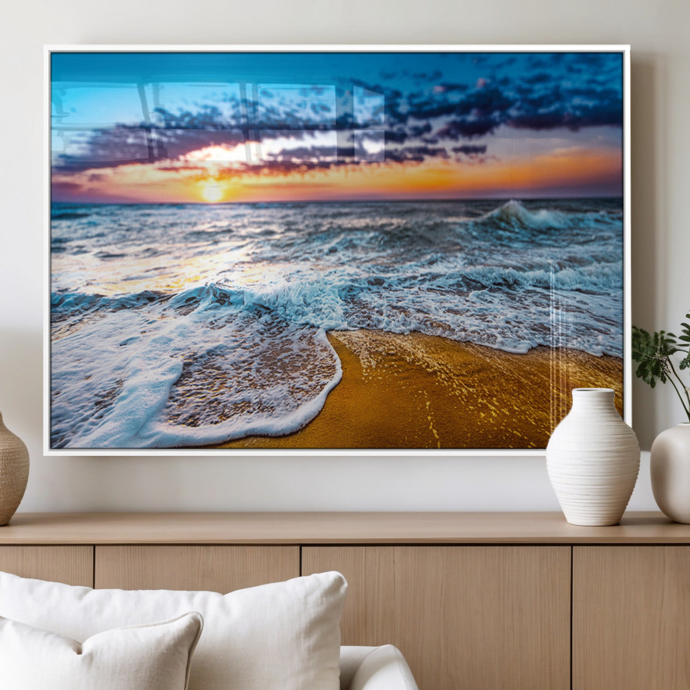 Beautiful ocean shoreline at sunset with foamy waves washing onto golden sand under a colorful sky – Wall Art Canvas Print.