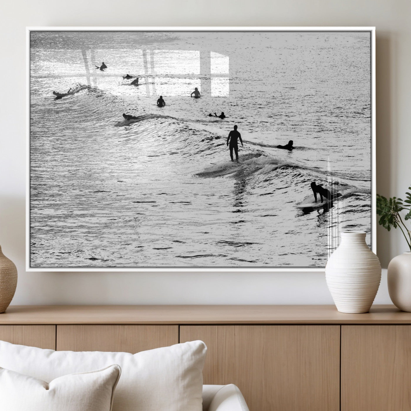 19970637-MGV-CV-60X30-3P_White-Black and white artistic view of surfers riding and paddling on waves in the ocean, capturing the dynamic motion and energy of surfing