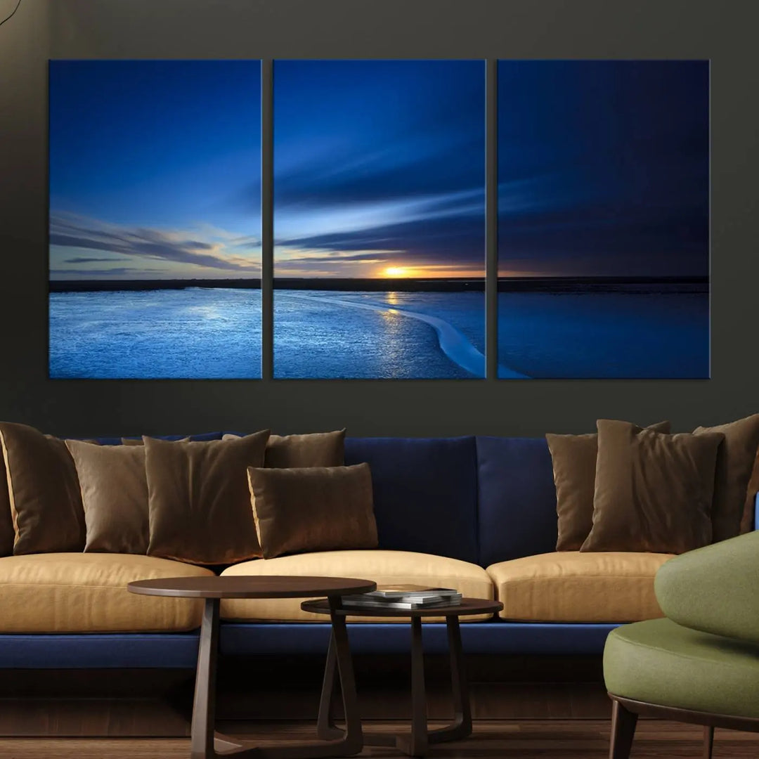 The living room features a triptych of the Wall Art Canvas Print Navy Sunset Lake Landscape Artwork, adding to its tranquil vibe.