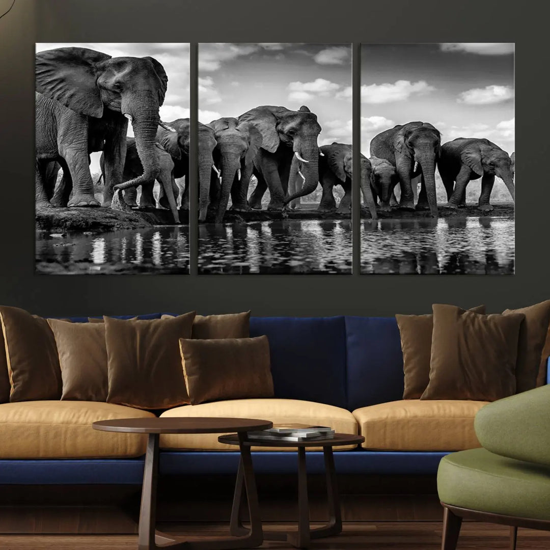 A stunning "Wall Art Animal Canvas Print" featuring a black and white photo of a herd of elephants drinking water is elegantly displayed, gallery wrapped on museum-quality canvas.