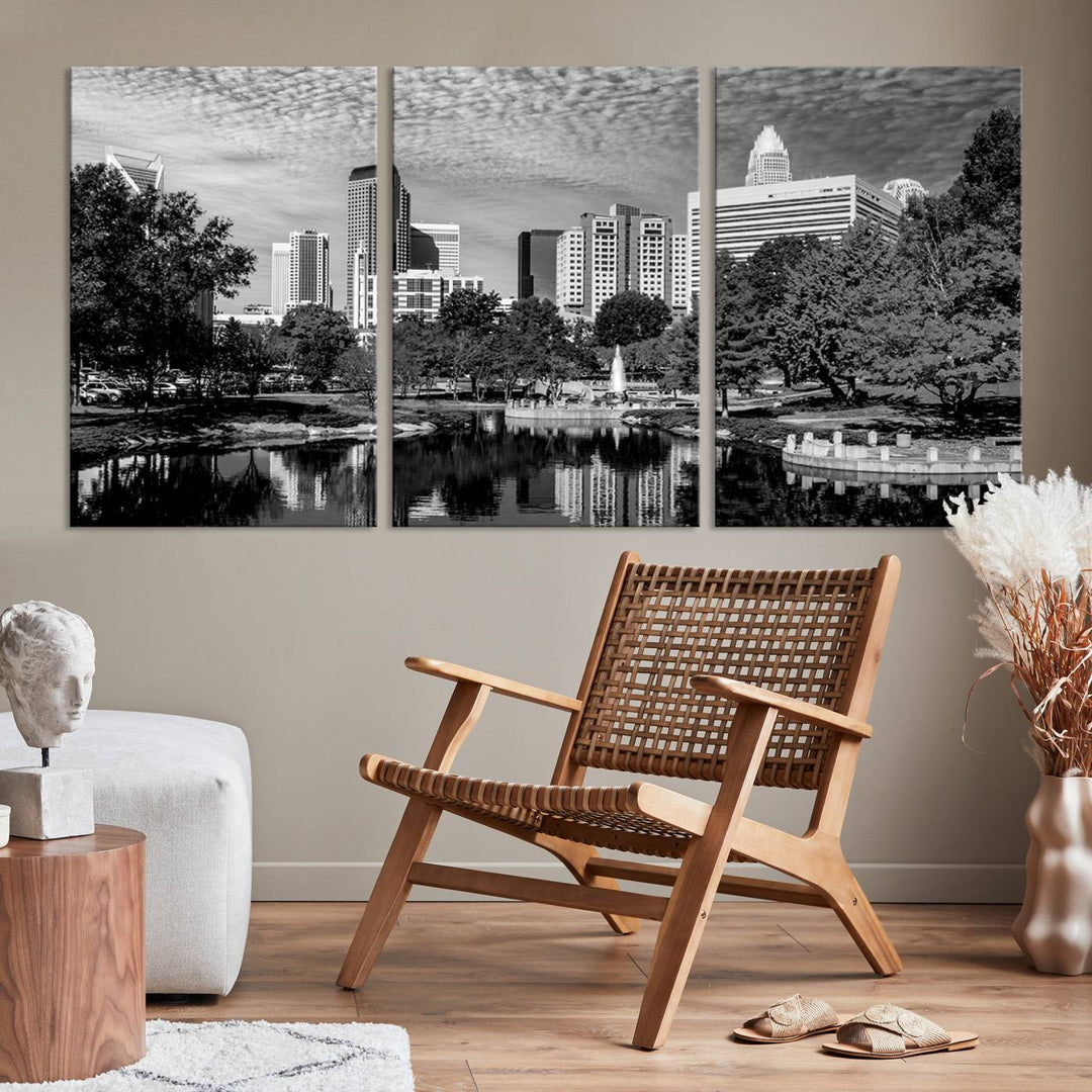 The living room features a captivating triptych titled "Charlotte City Cloudy Skyline Black and White Wall Art Cityscape Canvas Print," crafted on museum-quality canvas with UV-protective coating. Modern decor accentuates the dynamic scene.