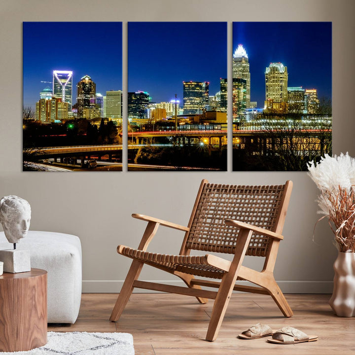 The Charlotte City Lights Night Blue Skyline Cityscape View Wall Art Canvas Print, showcasing an illuminated city skyline at night, is printed on museum-quality canvas with a UV-protective coating. Enhance your space with this stunning piece and enjoy free shipping with your purchase.