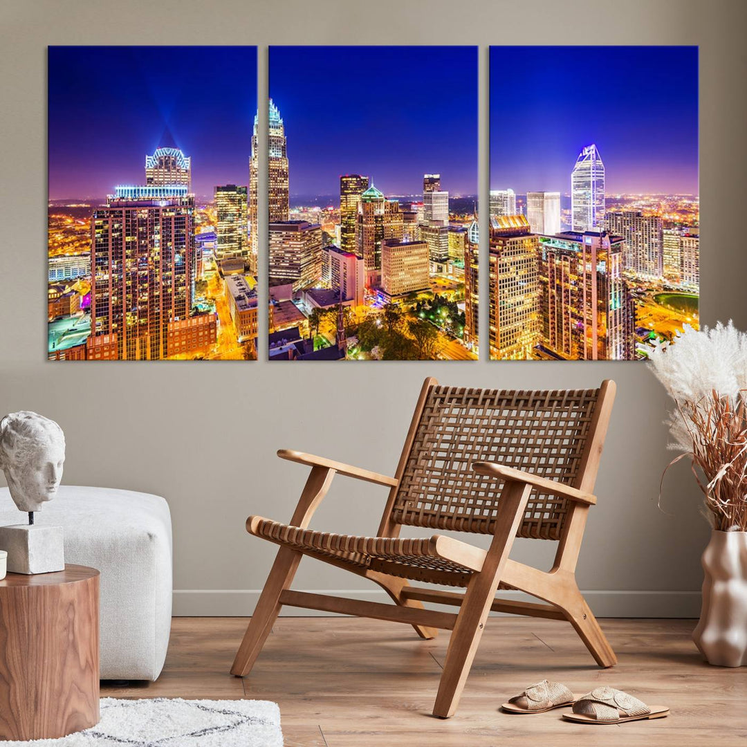 A modern living room features the Charlotte City Lights Night Blue Skyline Cityscape View wall art canvas print.