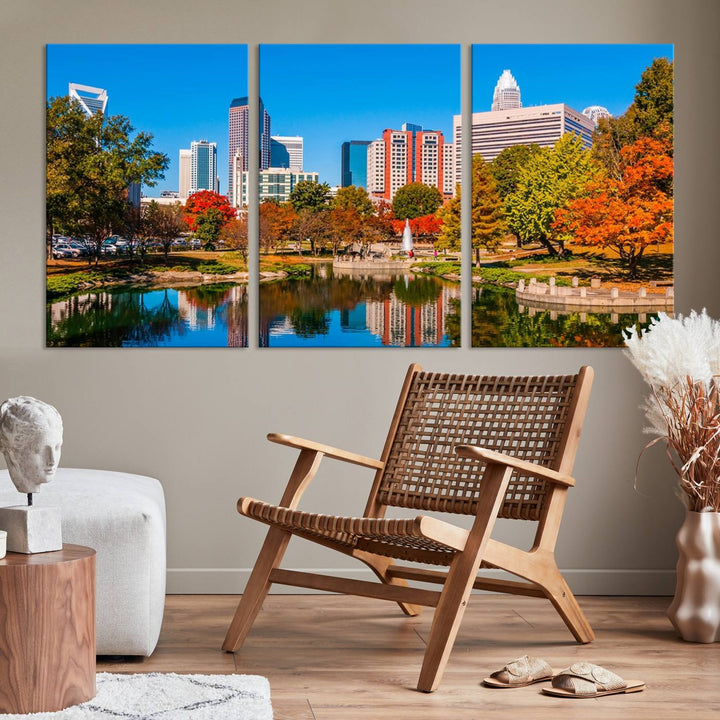 The Charlotte City Park at Fall Skyline Cityscape View wall art canvas print features a city panorama with a park and lake accented by autumn trees. It is mounted on museum-quality canvas with UV-protective coating and decorates the space.