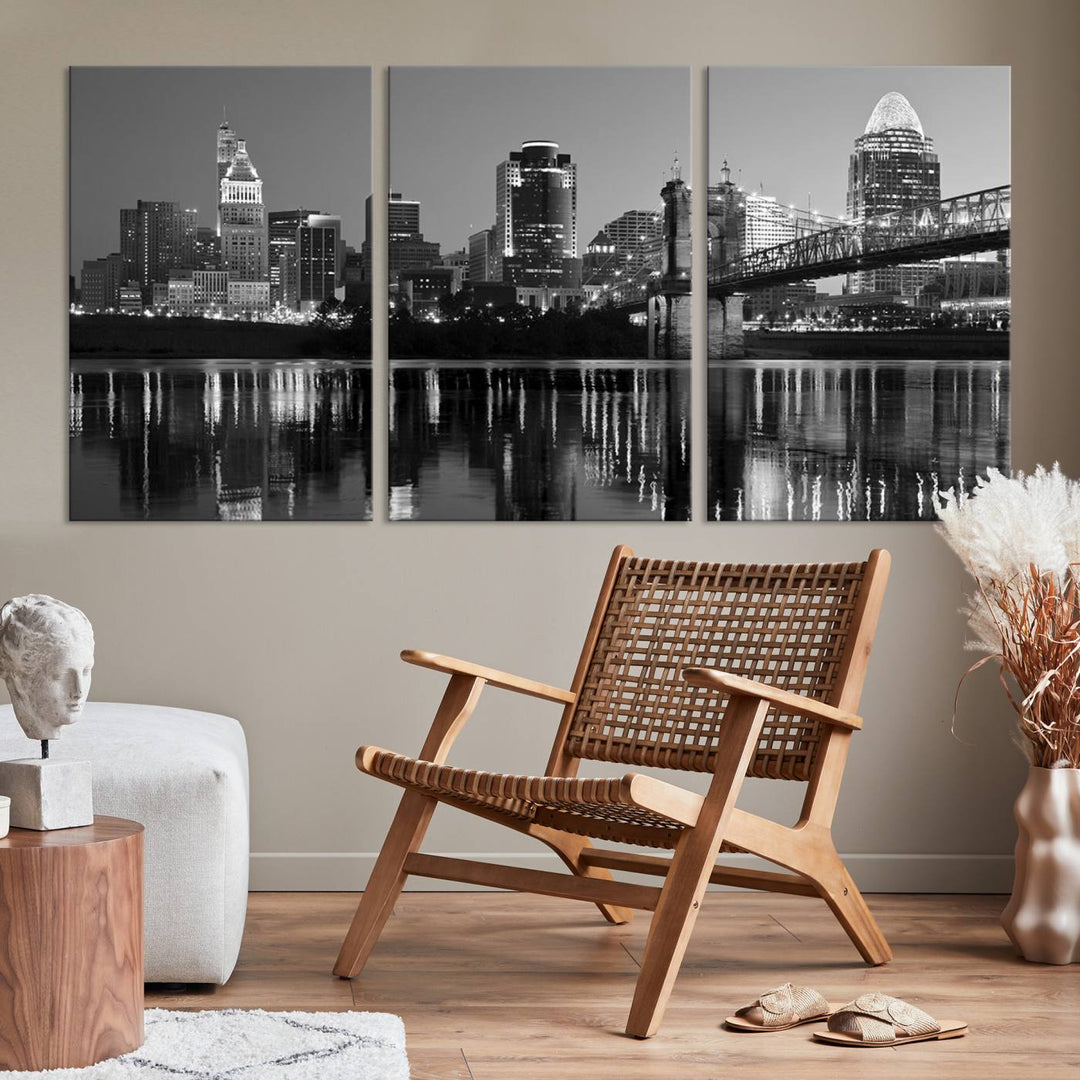 The wall showcases a ready-to-hang triptych of the Cincinnati City Lights Skyline in black and white, printed on museum-quality canvas.