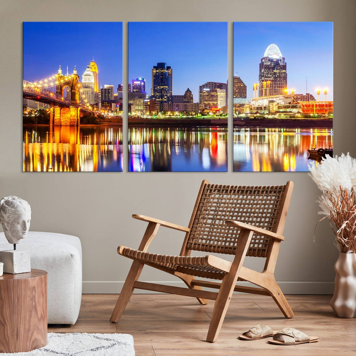 The "Cincinnati City Lights Night Skyline Cityscape View Wall Art Canvas Print" is a gallery-wrapped, museum-quality canvas illustrating a lit-up bridge and skyline at night. Enhanced with a UV-protective coating, this piece ensures lasting vibrancy.