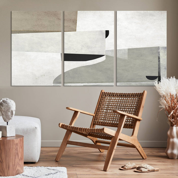 The Brown Gray Figures Abstract Wall Art Canvas Print is displayed as a triptych on a dark wall. The piece is gallery wrapped, offering a seamless finish and enhanced durability due to its UV-protective coating.