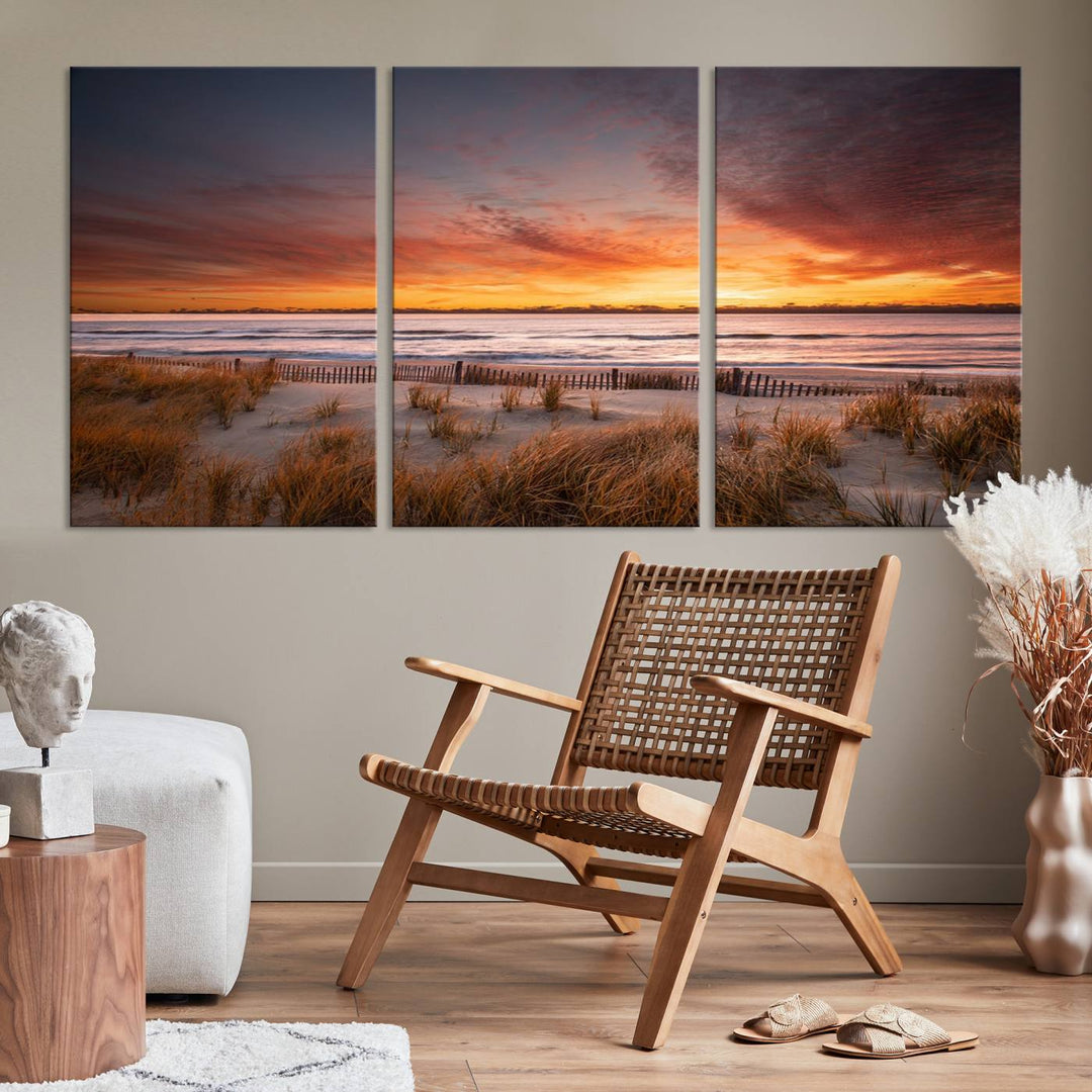 Sunset on The Beach Wall Art Canvas Print features a triptych of a beach at sunset with vivid orange skies, presented on museum-quality canvas. Each section is gallery wrapped, offering lasting beauty with its UV-protective coating.