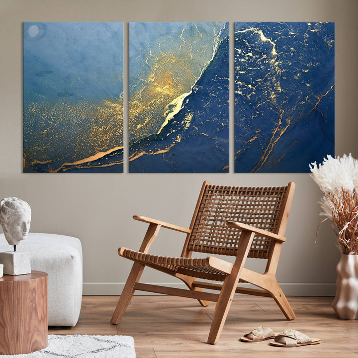 The Navy Blue Yellow Twinkle Wall Art Canvas Print, featuring an abstract design in gold and blue, enhances a modern living room as it adorns a white wall with its gallery-wrapped, museum-quality canvases for an exquisite touch.