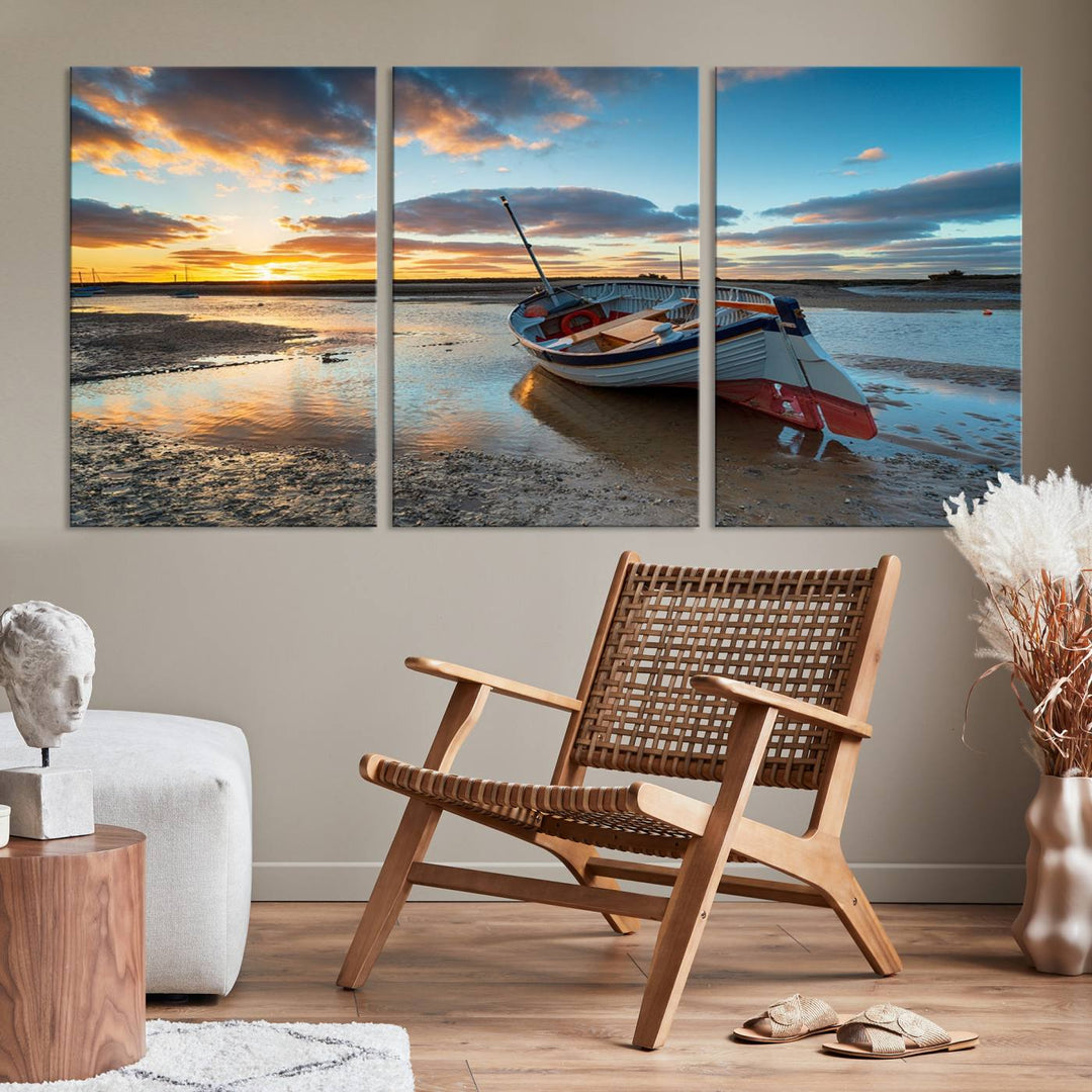 The "Small Boat At The Beach Sunset Wall Art Canvas Print," a three-panel masterpiece crafted on museum-quality canvas, hangs elegantly.