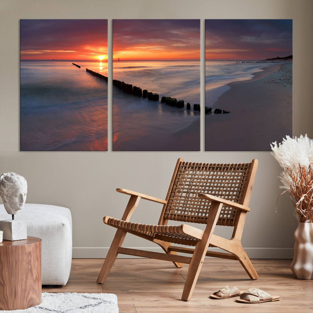 In a modern living room, the Sunset Beach Wall Art Canvas Print is displayed above. This triptych, printed on museum-quality canvas with a UV-protective coating, ensures lasting brilliance. It's ready to hang and brings an elegant touch to your space.