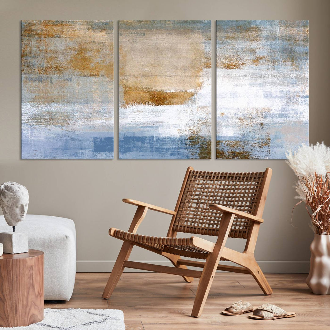 The Blue Multi Panel Abstract Wall Art Canvas Print, featuring an elegant blend of blue, beige, and brown tones, hangs gracefully on the wall, adding a contemporary touch to the space.