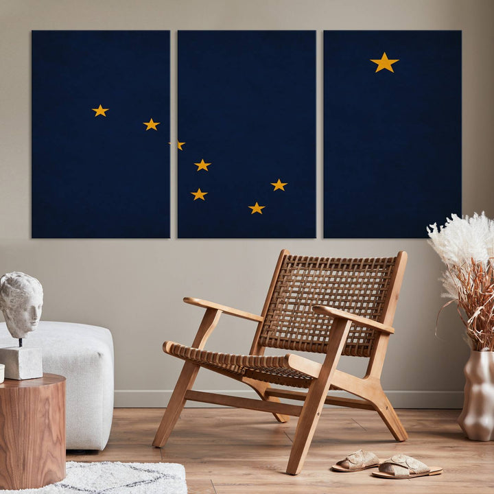 A contemporary living room featuring a triptych artwork of stars on a navy background, accentuated by the striking Alaska States Flag Wall Art Canvas Print.