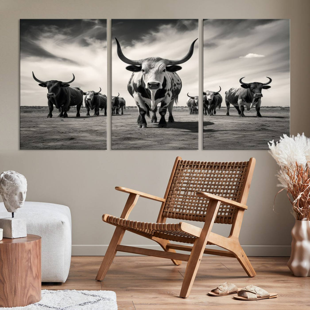 The Black and White Longhorn Cattle Wall Art, featuring a three-panel display of cowboy Western longhorns walking toward the viewer, enhances your space with its striking presence, adding a touch of Western decor.