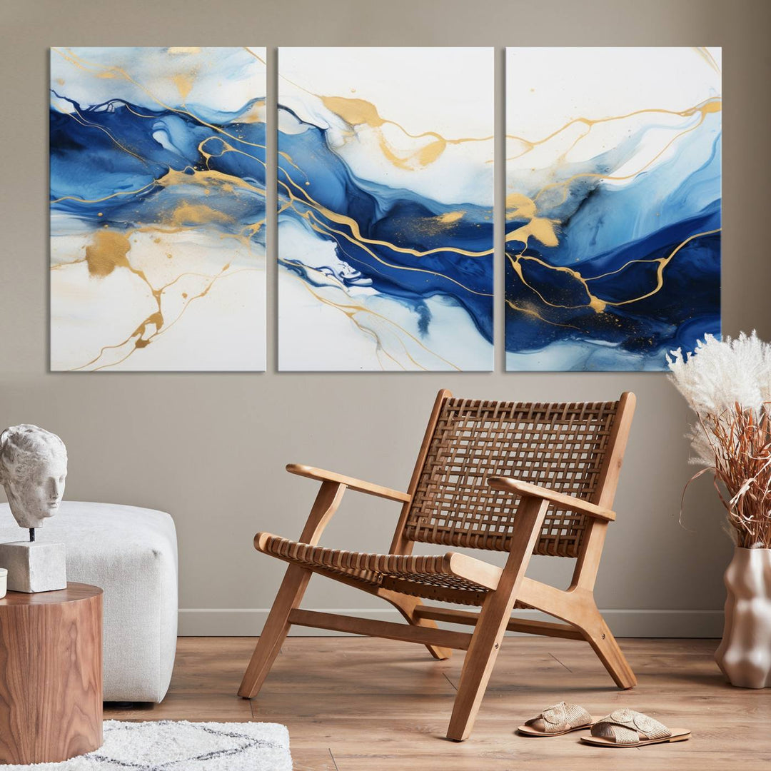 The Blue Abstract Wall Art is displayed as a triptych on museum-quality canvas, showcasing a blue and gold abstract design. The artwork includes a UV-protective coating to maintain its vibrancy and comes with the benefit of free shipping.