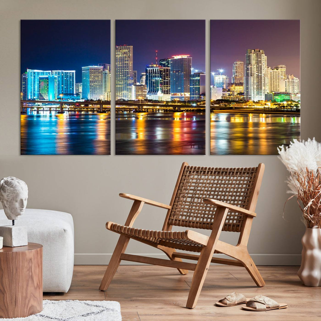 The Wall Art MIAMI Canvas Print features a stunning triptych of a city skyline at night, with vibrant lights reflecting on the water. This gallery-wrapped piece on museum-quality canvas delivers an exquisite finish.