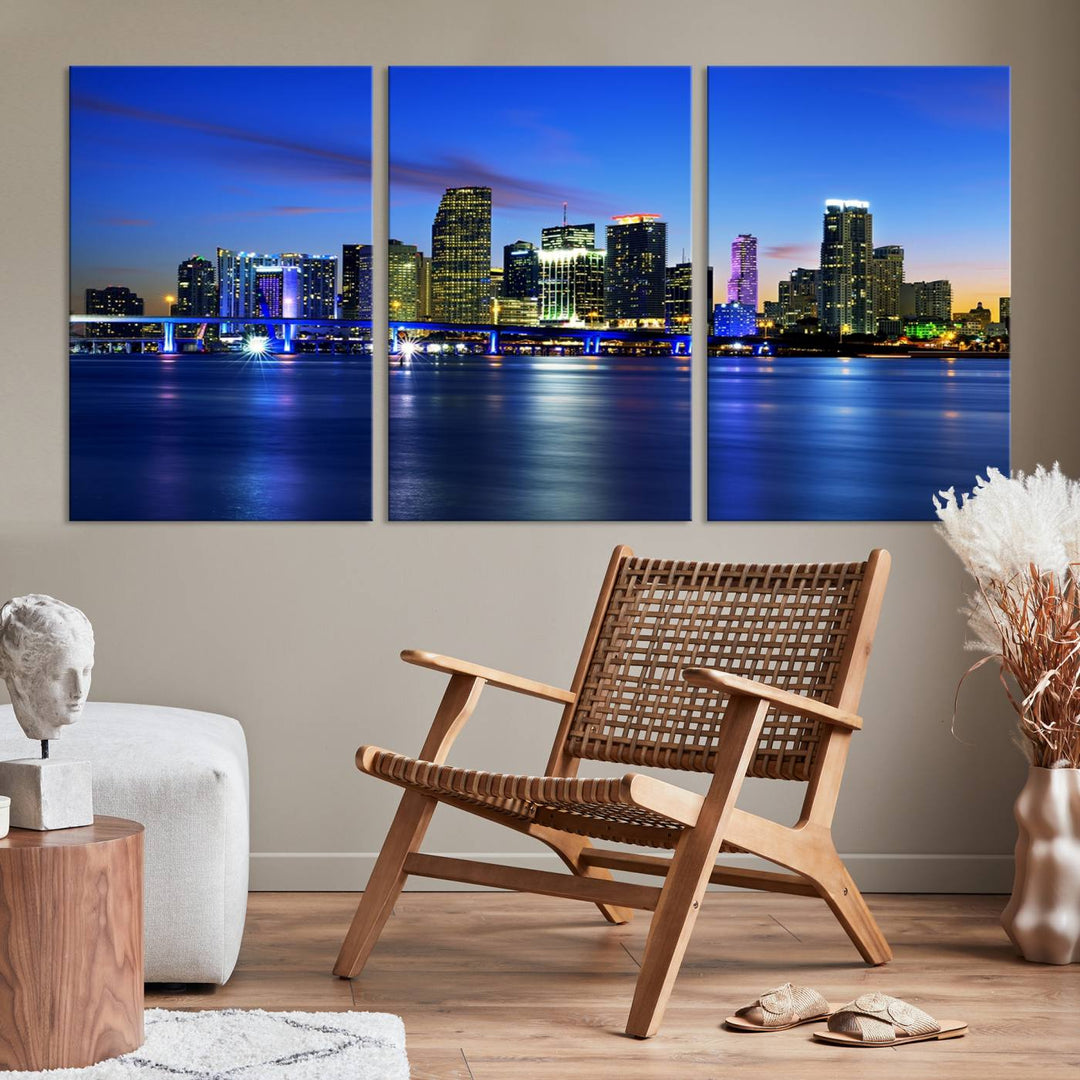 The modern living room showcases a striking Miami Blue Night Wall Art canvas print on the wall. The artwork is gallery wrapped on museum-quality canvas, ensuring durability and elegance.