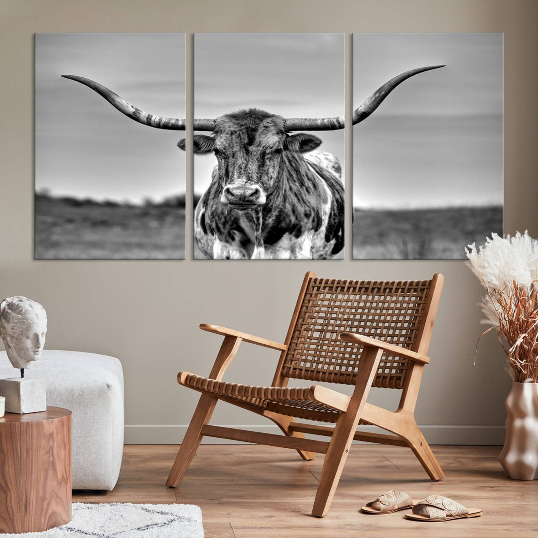 The Texas Longhorn Cow Wall Art, featuring a black and white image of a longhorn bull on canvas, brings charm to the room with its sophisticated appeal.