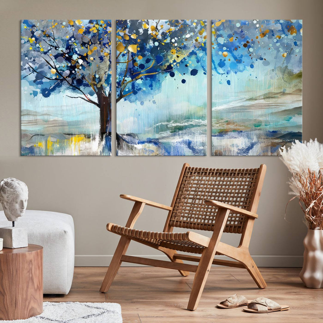 A modern living room features a three-panel Watercolor Style Abstract Tree Printing Wall Art Canvas in vibrant blue and yellow, crafted on museum-quality material.