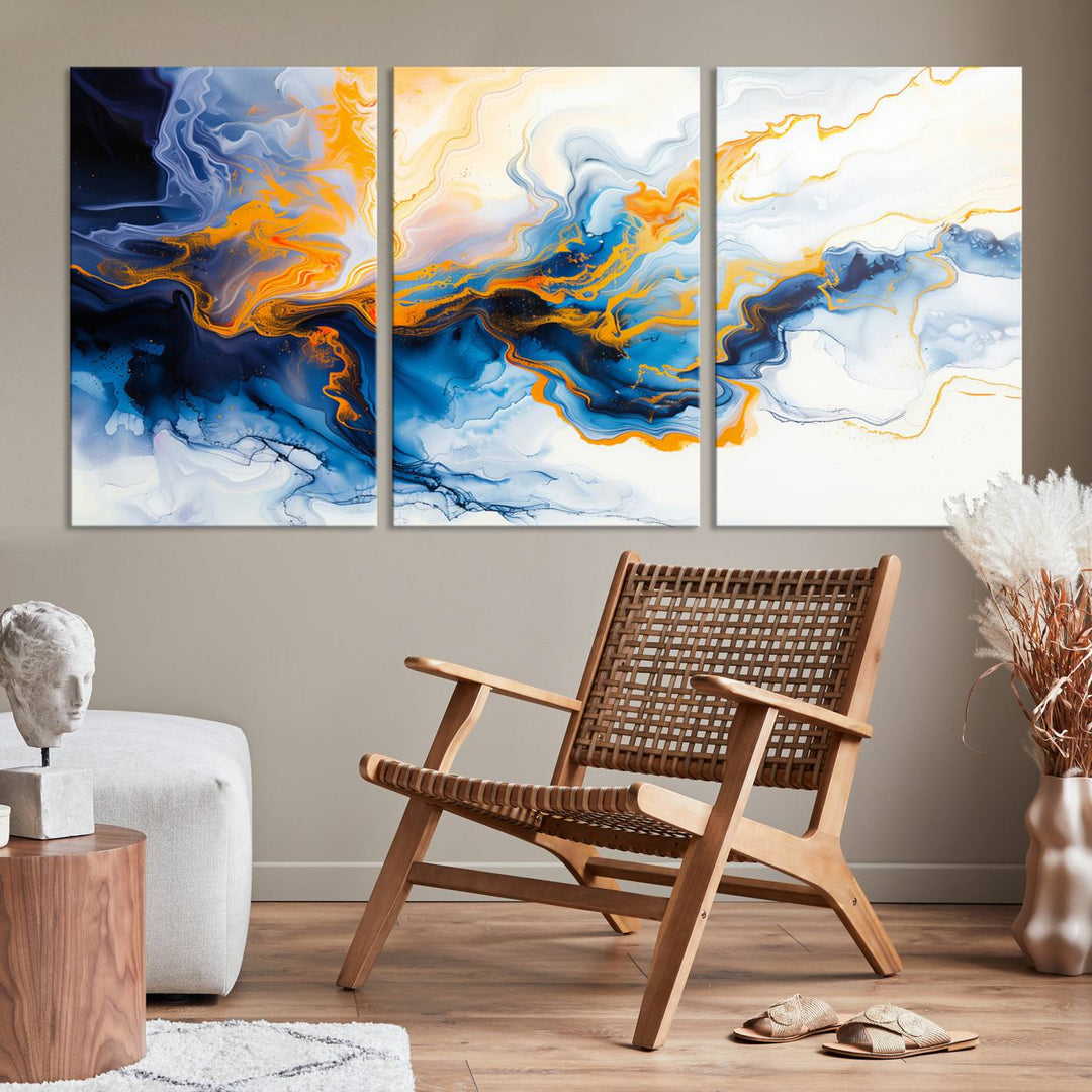 A stunning Fluid Alcohol Ink Wall Art with Gold Wall Art Canvas Print, featuring vibrant blue, orange, and white swirls, adorns the wall. This gallery-quality finish adds an exquisite touch to any living space.