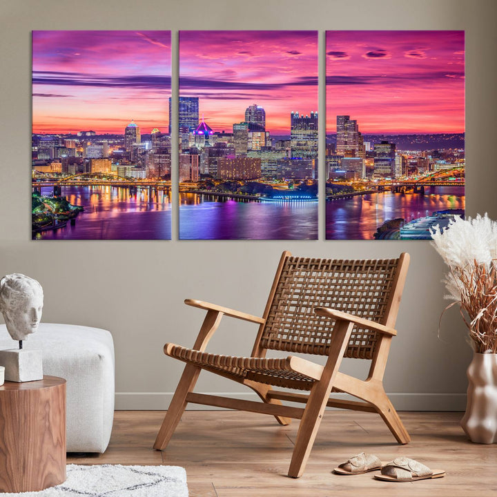 The Pittsburg Wall Art Canvas Print, showcasing a vibrant sunset glow over the city skyline and crafted by a professional artisan, adorns the space.