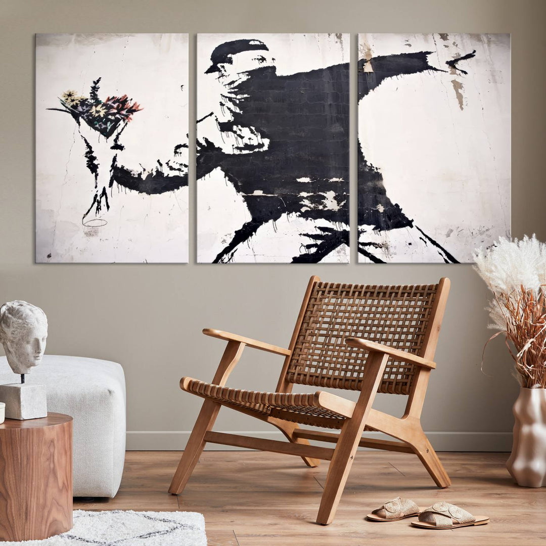 The living room features a split-panel art piece named "Banksy Flower Throw Graffiti Street Wall Art Canvas Print," gallery wrapped on museum-quality polycotton canvas and accentuated by modern decor elements.