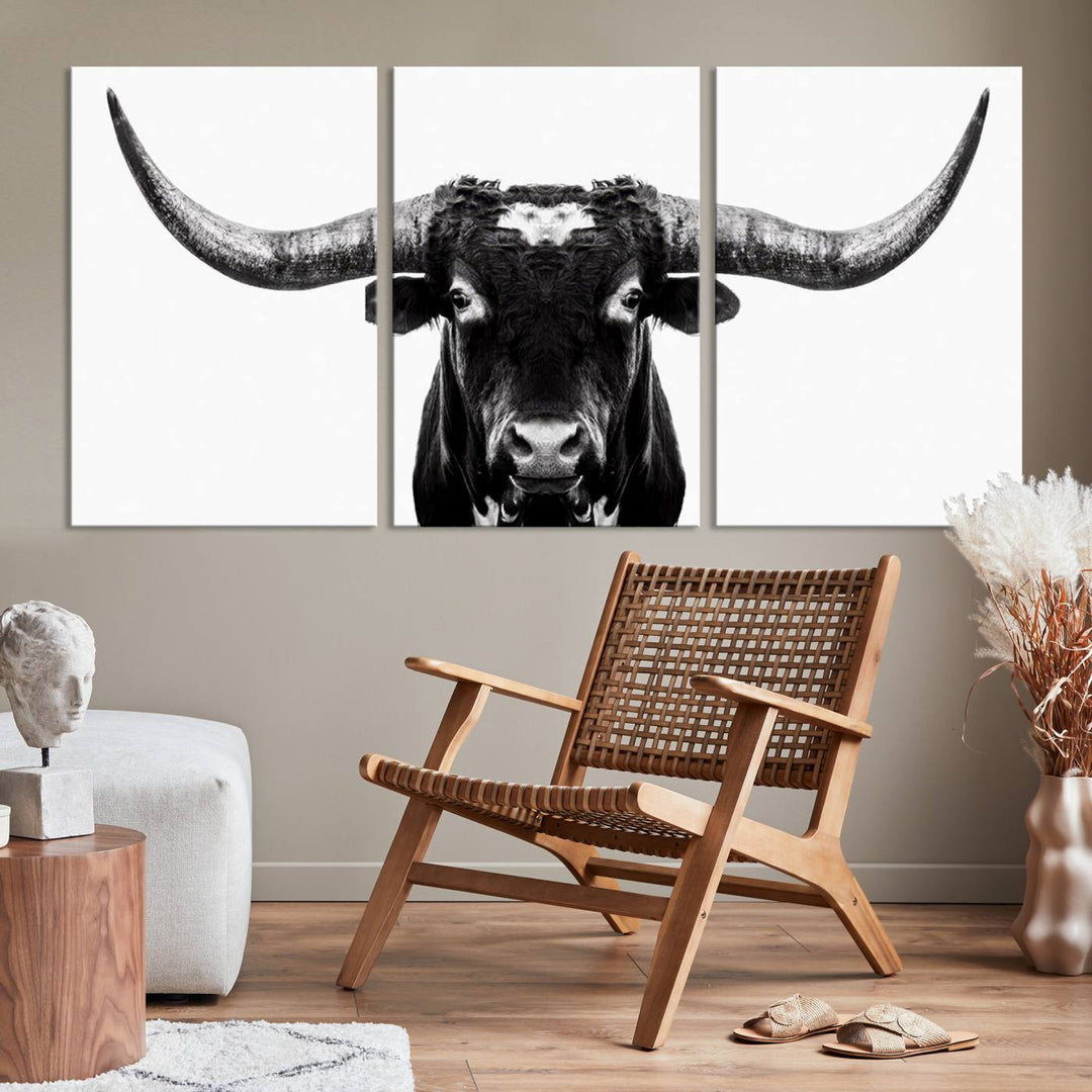 The living room is adorned with the Texas Cow Longhorn Wall Art Canvas Print in Black and White—framed and ready to hang.