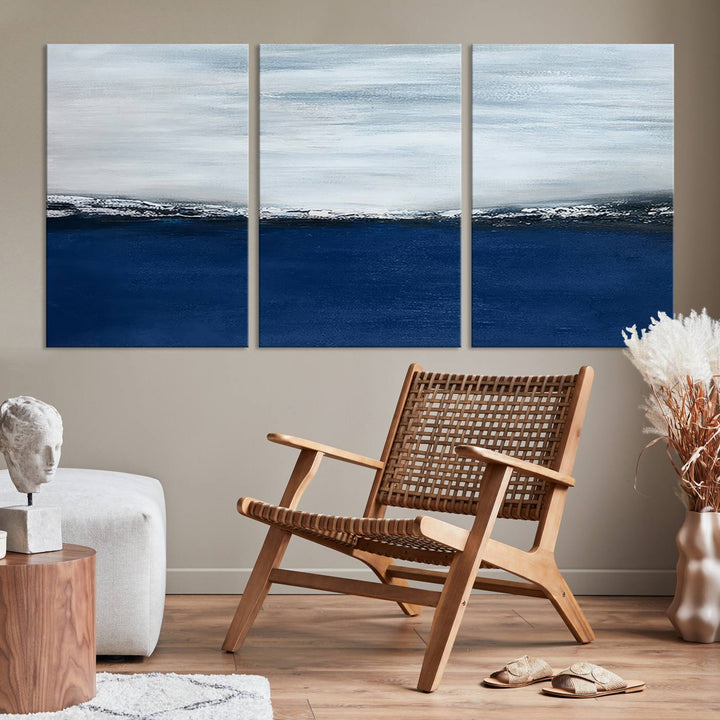 The modern living room is enhanced by the Navy Blue Abstract Wall Art Canvas Print on the wall, crafted as handmade wall art with a gallery-quality finish.