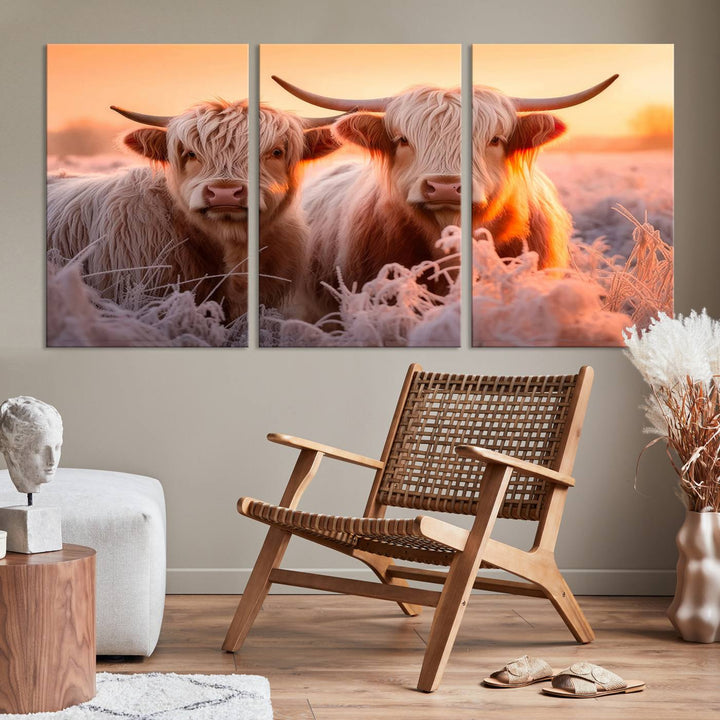 The "Highland Cows at Sunrise Wall Art Canvas Set" beautifully captures a serene and rustic farmhouse aesthetic, portraying two Highland cows in a frosty landscape at sunrise.