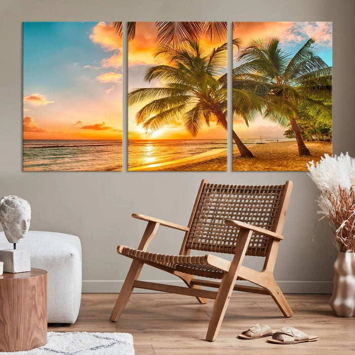 The Tropical Sunset Wall Art Print features a vibrant beach scene with palm trees and an ocean view highlighted by a golden sunset.