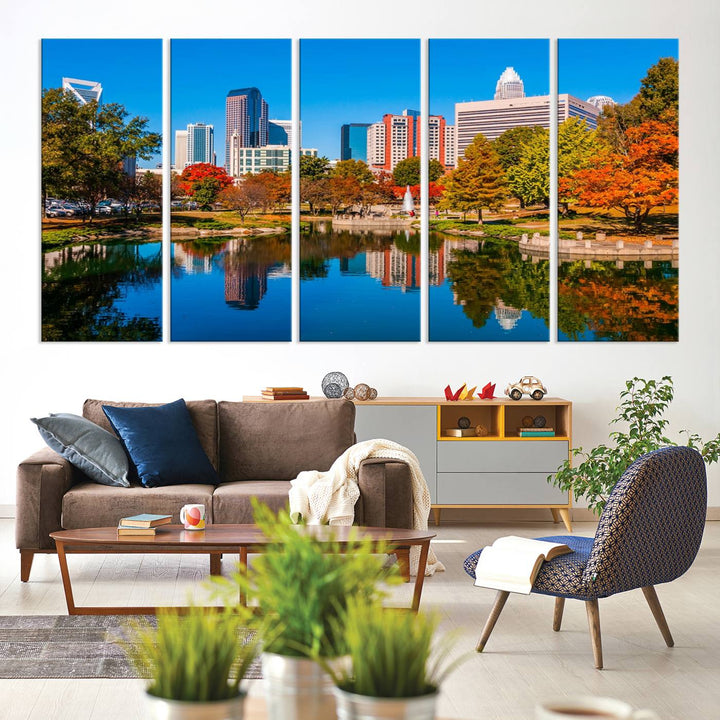 The "Charlotte City Autumn Morning Blue Skyline Cityscape View Wall Art Canvas Print" showcases a cityscape with vibrant autumn trees reflected in a lake. Its gallery-wrapped edges add depth to the scene, while the UV-protective coating ensures lasting brilliance.