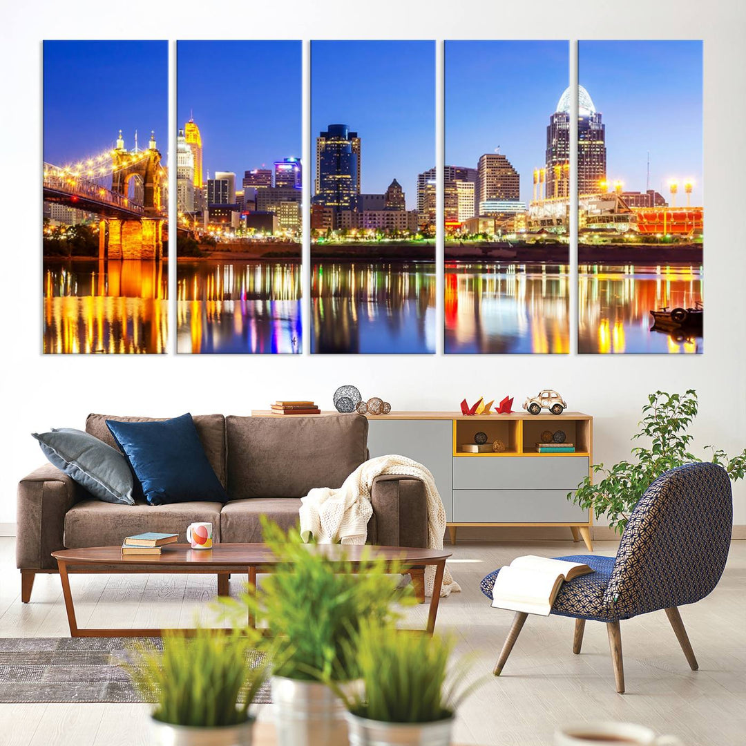 The "Cincinnati City Lights Night Skyline Cityscape View Wall Art Canvas Print" is a gallery-wrapped, museum-quality canvas illustrating a lit-up bridge and skyline at night. Enhanced with a UV-protective coating, this piece ensures lasting vibrancy.