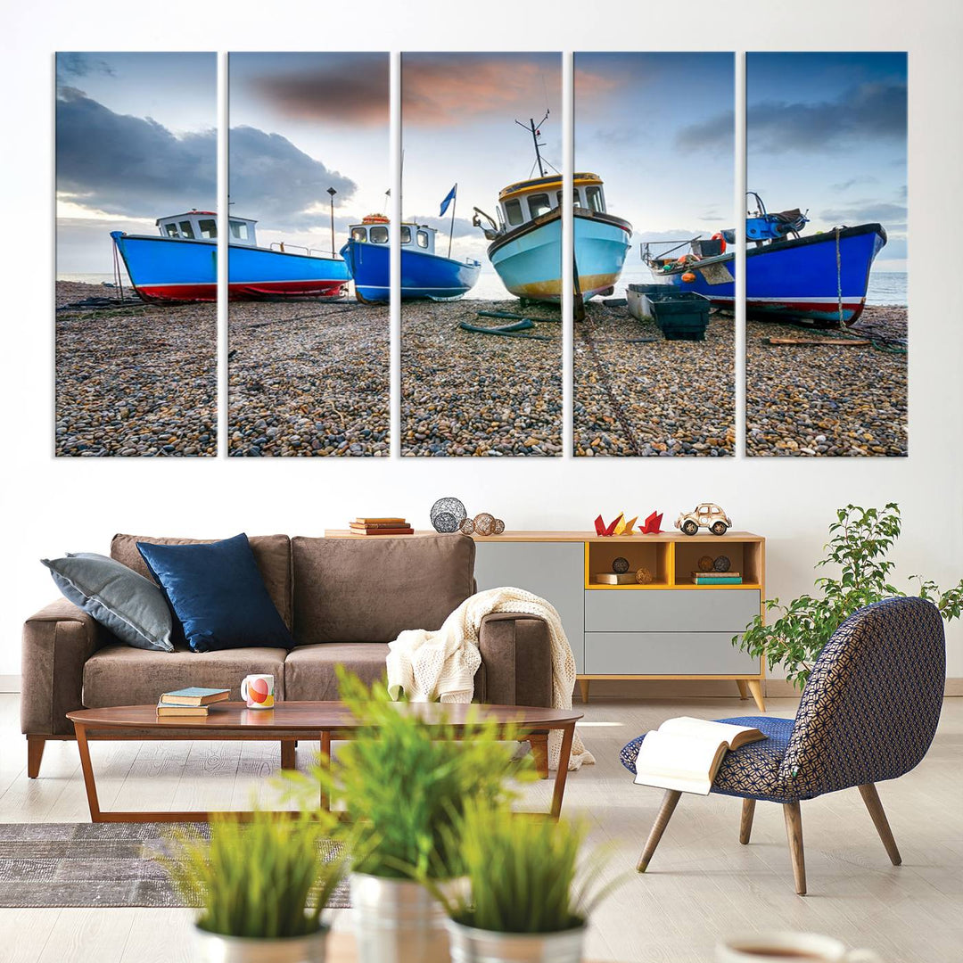 The "Big Boats On The Beach Wall Art Canvas Print" is a stunning piece featuring three museum-quality panels depicting fishing boats on a pebbled shore. Ready to hang and featuring UV-protective coating, it serves as an elegant addition to your home décor.