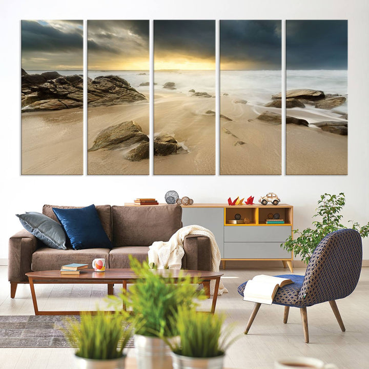 A gallery-wrapped, three-panel artwork titled "Rocks and Waves Wall Art Canvas Print" depicts a rocky beach at sunset. Each canvas showcases museum-quality craftsmanship and a UV-protective coating to maintain its vibrant colors.