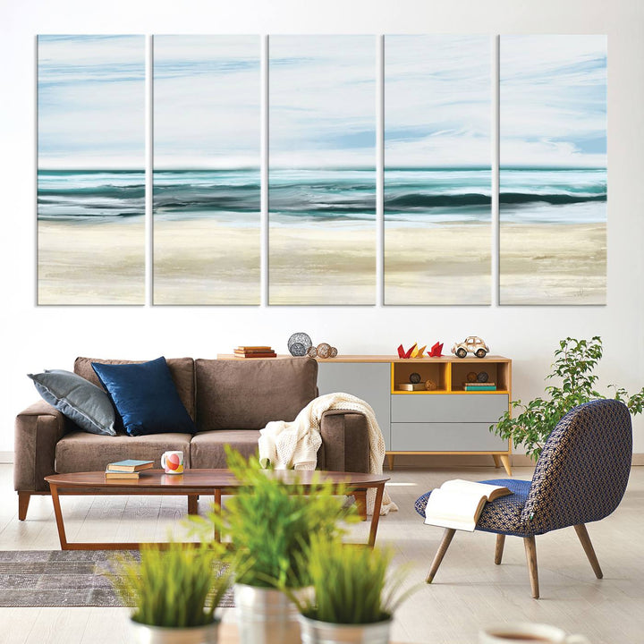 The room features the Ocean Abstract Wall Art Canvas Print, a triptych beach painting on museum-quality canvas with a gallery-wrapped finish and UV-protective coating.