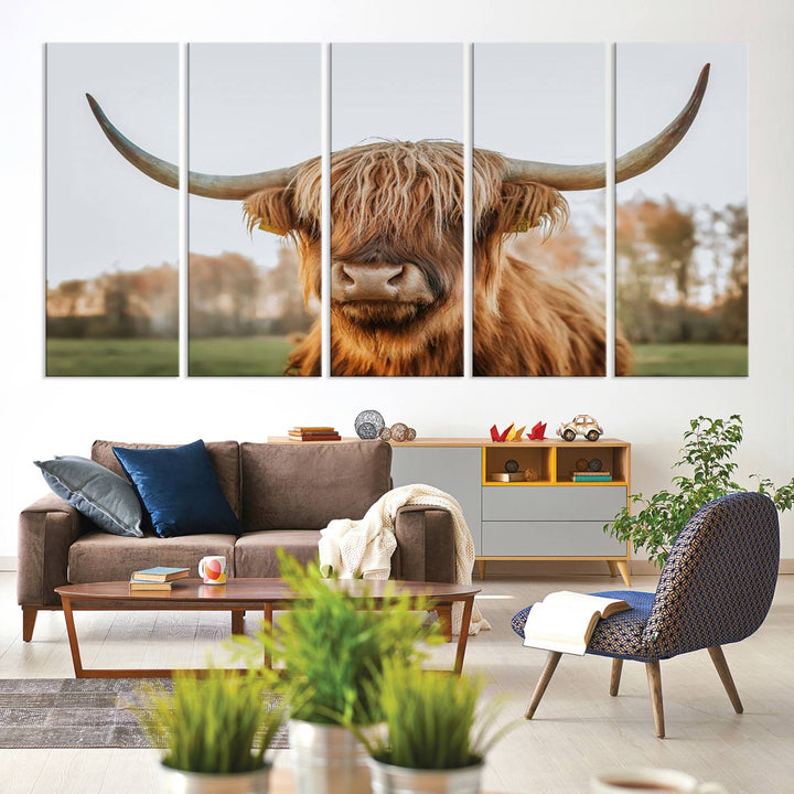 A Highland Cow Animal Scottish Cattle Art Print Farmhouse Wall Art Canvas Print hangs in the living room, adding a touch of rustic farmhouse decor.