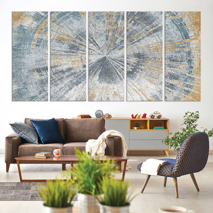 The Radiant Abstract Wood Rings Canvas Art, a modern triptych wall decor, enhances the contemporary style of the living room with its blue, white, and gold hues.