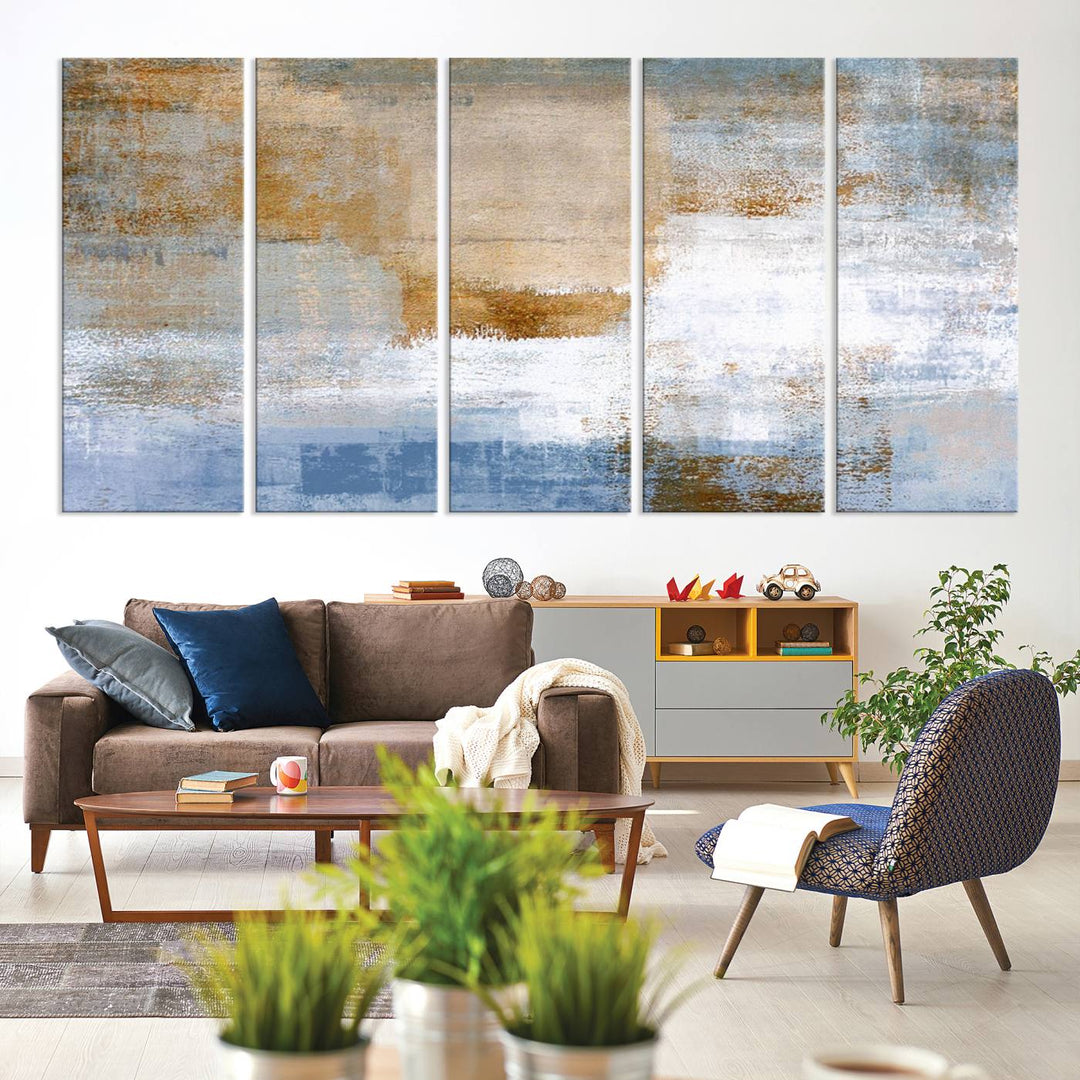 The Blue Multi Panel Abstract Wall Art Canvas Print, featuring an elegant blend of blue, beige, and brown tones, hangs gracefully on the wall, adding a contemporary touch to the space.