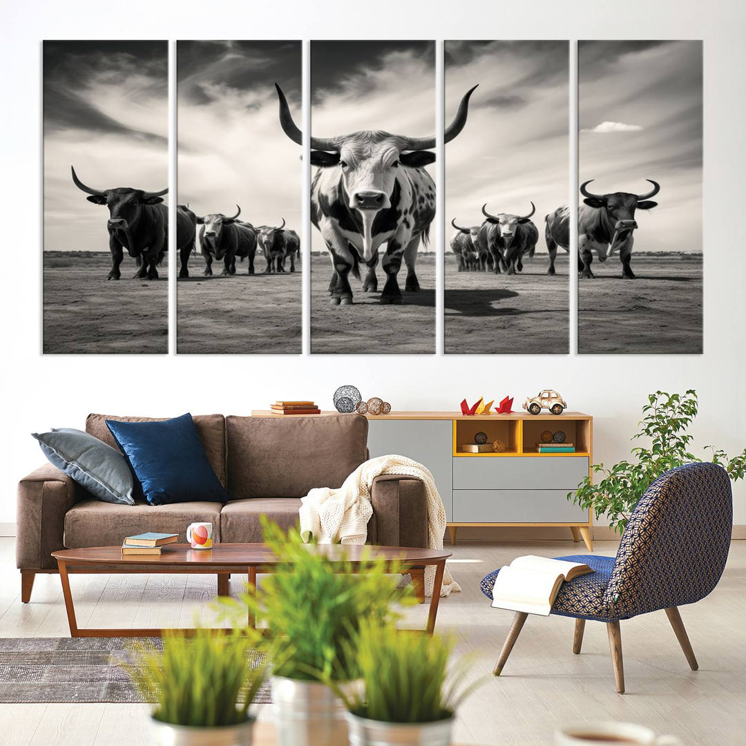 The Black and White Longhorn Cattle Wall Art, featuring a three-panel display of cowboy Western longhorns walking toward the viewer, enhances your space with its striking presence, adding a touch of Western decor.