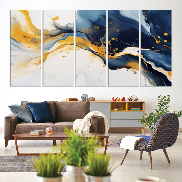 The Blue and Gold Abstract Fluid Canvas Art, with its swirling patterns, adorns the wall. This modern wall art beautifully complements the contemporary interior decor, adding an elegant touch with its rich blue, gold, and white tones.