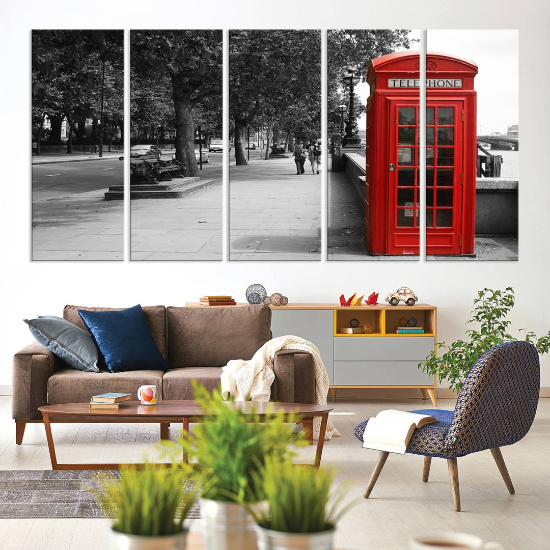 The London Phone Club Wall Art is a stunning piece that showcases a red telephone box set in a black and white street scene on museum-quality canvas. It is gallery wrapped with a UV-protective coating to preserve its vibrant charm.