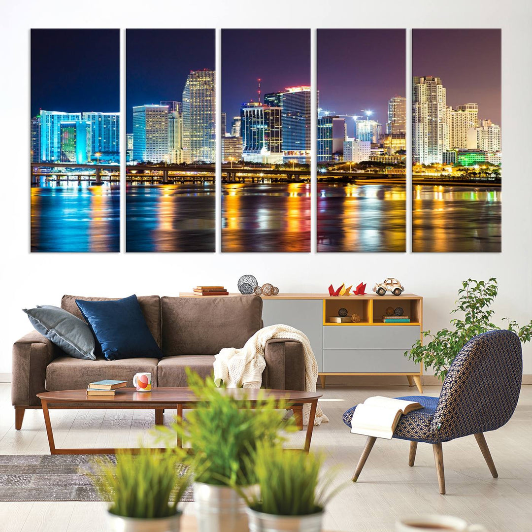 The Wall Art MIAMI Canvas Print features a stunning triptych of a city skyline at night, with vibrant lights reflecting on the water. This gallery-wrapped piece on museum-quality canvas delivers an exquisite finish.