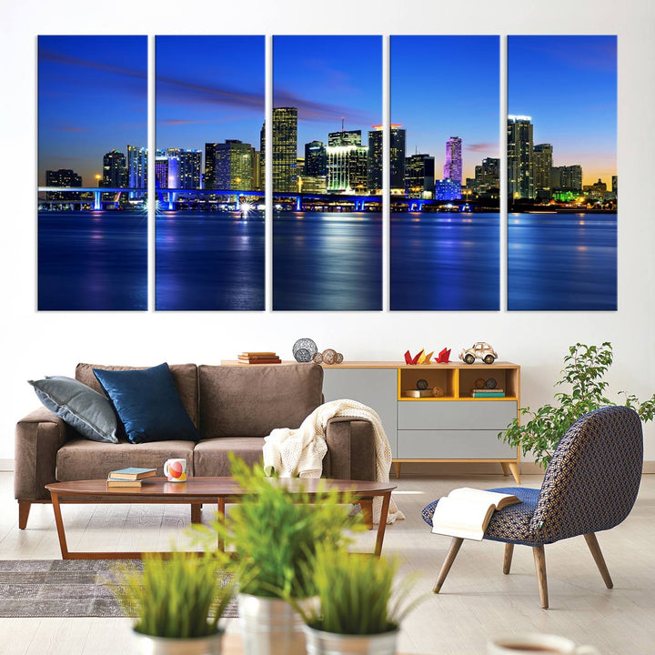 The modern living room showcases a striking Miami Blue Night Wall Art canvas print on the wall. The artwork is gallery wrapped on museum-quality canvas, ensuring durability and elegance.