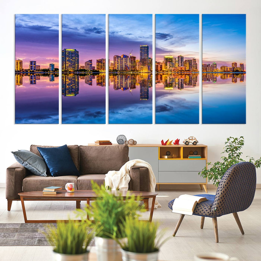 The Miami City Wall Art Canvas Print, featuring a three-panel depiction of a city skyline at sunset reflected in water, beautifully enhances the wall. Made with museum-quality canvas and a UV-protective coating, it comes ready to hang.