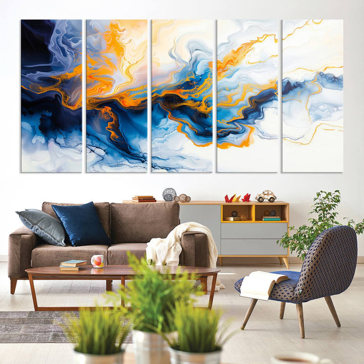 A stunning Fluid Alcohol Ink Wall Art with Gold Wall Art Canvas Print, featuring vibrant blue, orange, and white swirls, adorns the wall. This gallery-quality finish adds an exquisite touch to any living space.