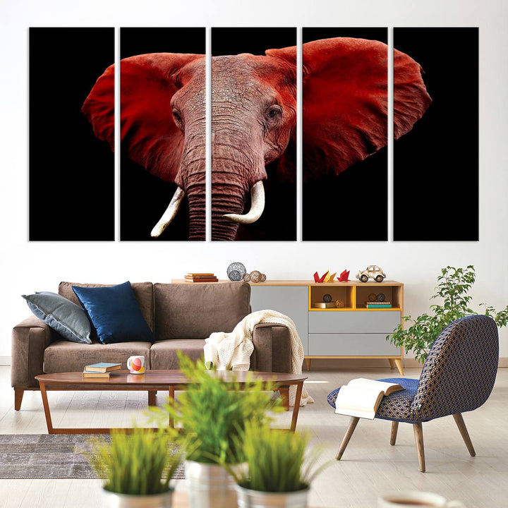 A Wall Art Canvas Print in the modern living room features a three-panel premium design of a red elephant face.