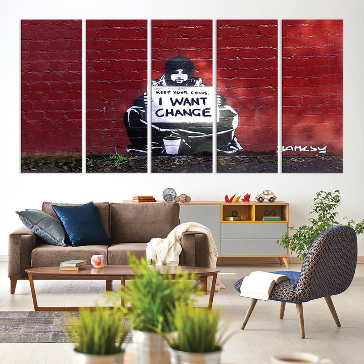 The living room showcases a triptych of stencil artwork on museum-quality canvas, featuring the Banksy I Want Change Graffiti Abstract Wall Art Canvas Print. This captivating piece depicts a person holding a sign that says "I want change" and is finished with a UV-protective coating to ensure long-lasting beauty.